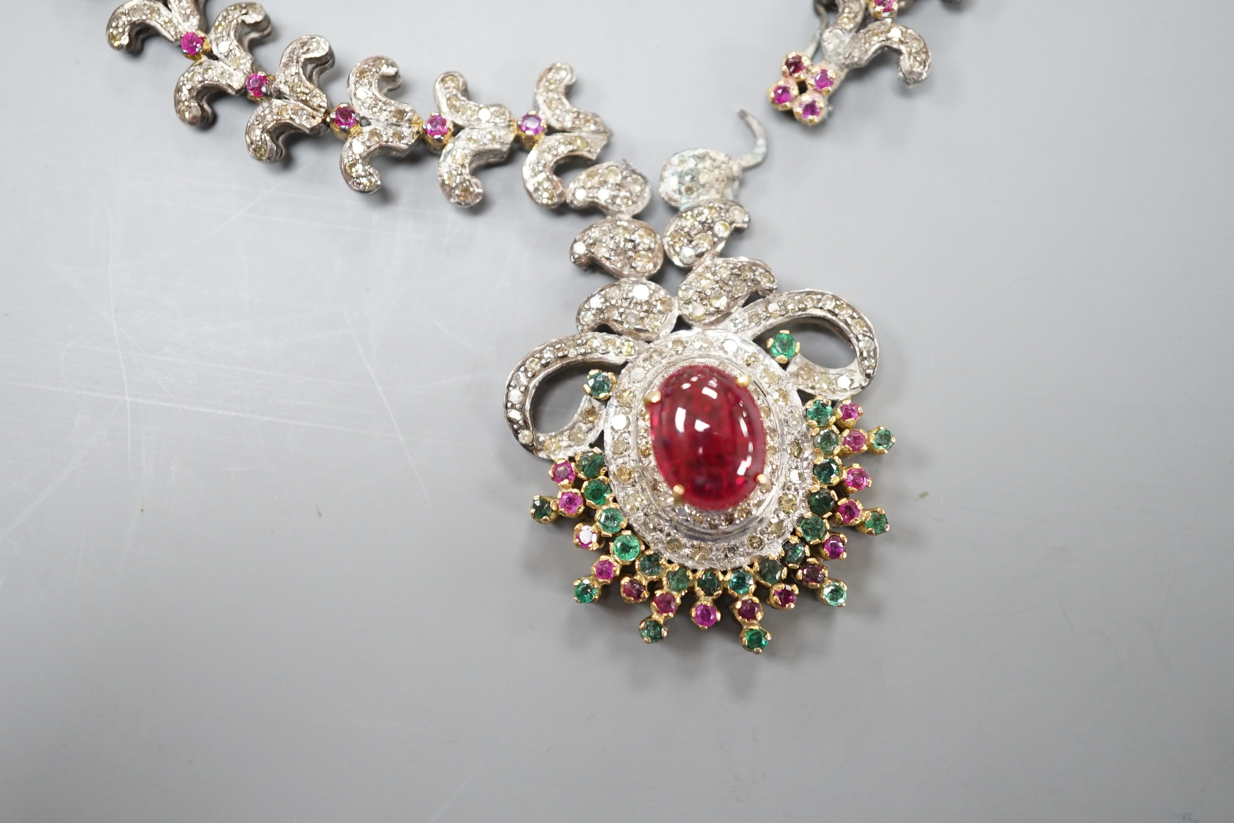 An Indian white and yellow metal, diamond, ruby and gem set necklace, 46cm and pair of matching earrings.